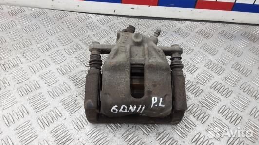 Суппорт тормозной передний левый nissan note E11