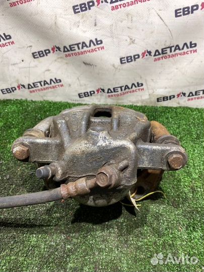 Суппорт тормозной передний левый Nissan Note E11