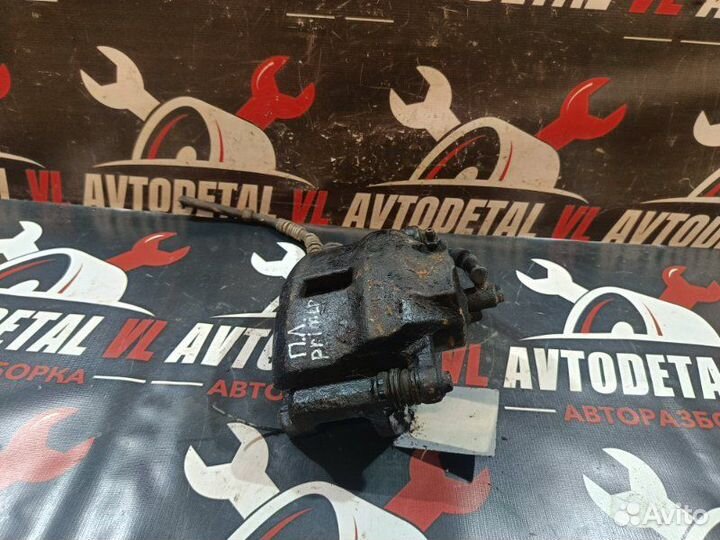 Суппорт тормозной передний левый Nissan Primera