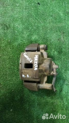 Суппорт тормозной передний левый Mazda Familia BJ