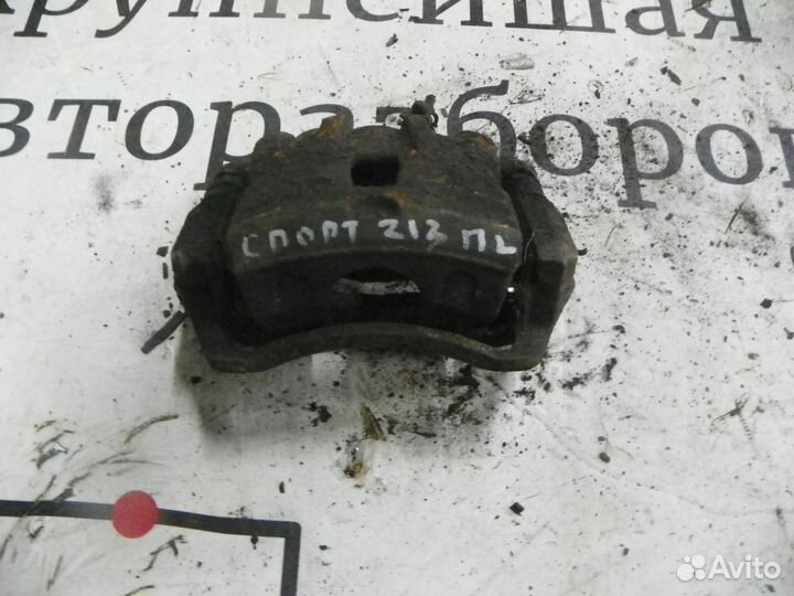 Суппорт тормозной передний левый Kia Sportage