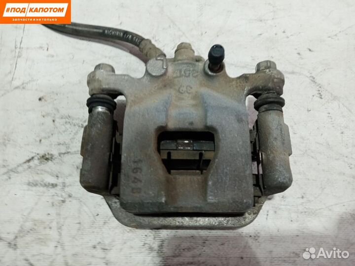 Суппорт тормозной задний левый Nissan Teana J32