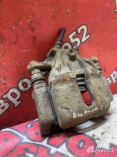 Суппорт тормозной передний левый Nissan Almera G15