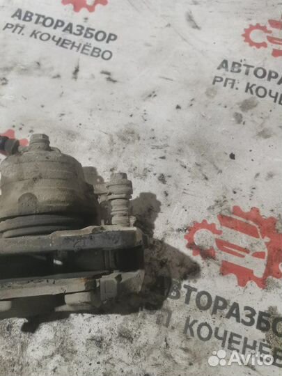 Суппорт тормозной передний левый Nissan Sunny