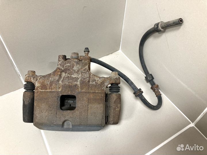 Суппорт тормозной пер левый Mitsubishi Lancer X