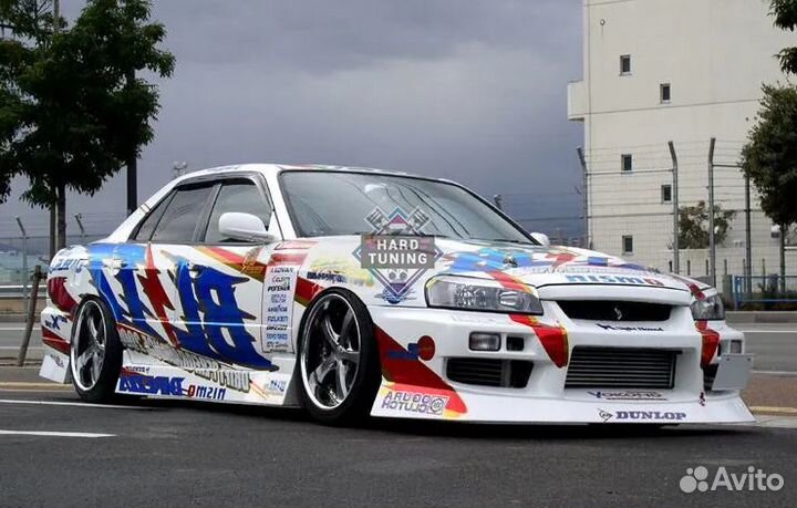 Передний бампер Uras Nissan Skyline R34