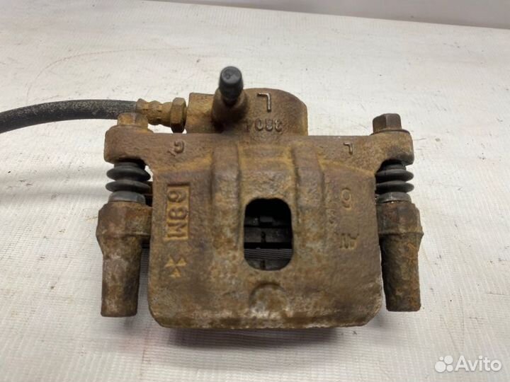 Суппорт тормозной задний левый Mitsubishi Lancer 9