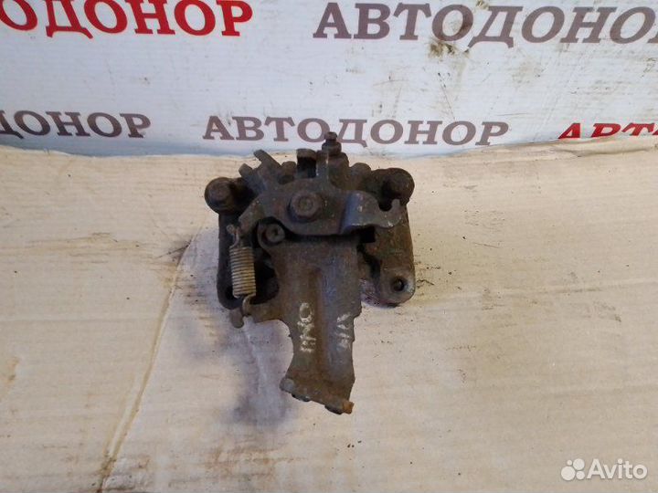 Суппорт тормозной задний левый Nissan Almera Tino