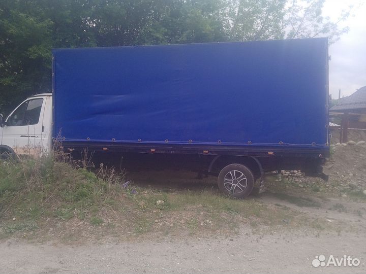 Водитель на своем грузовом автомобиле газель