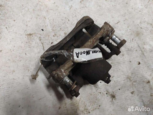 Суппорт тормозной 41011JN00A передний Nissan Teana