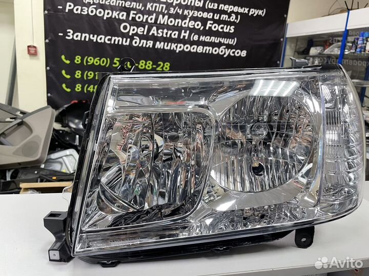 Фара левая Toyota Land Cruiser 100 212-11H9L-LD-EM