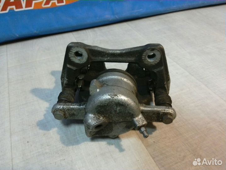 Суппорт тормозной передний левый Nissan Almera G15