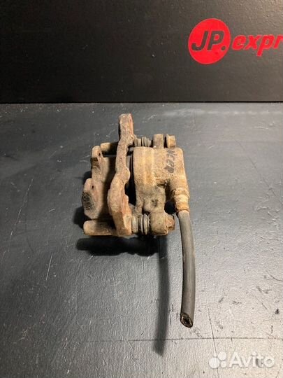 Суппорт тормозной задний левый Mitsubishi Lancer 9